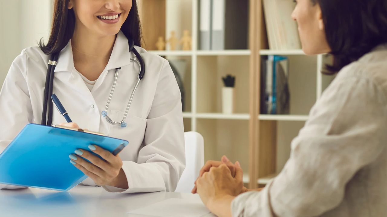 Healthcare provider reviewing notes with a patient, reflecting the documented results and client experience highlighted in Proactive Marketing reviews